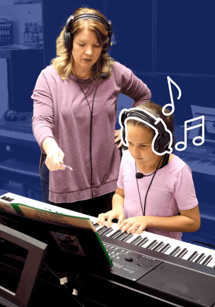 Student with headphones learning piano on a keyboard from teacher with headphones.